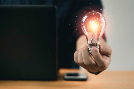 Entre as opções, está o Curso Geral de Propriedade Intelectual à Distância (Foto: Magnific.com) Mão de uma pessoa segurando lâmpada com luz brilhante indicando pensamento criativo
